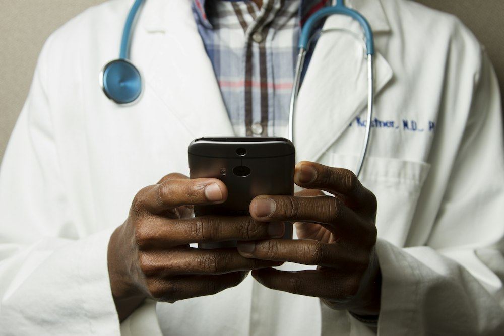 Healthcare worker with tablet supporting patient